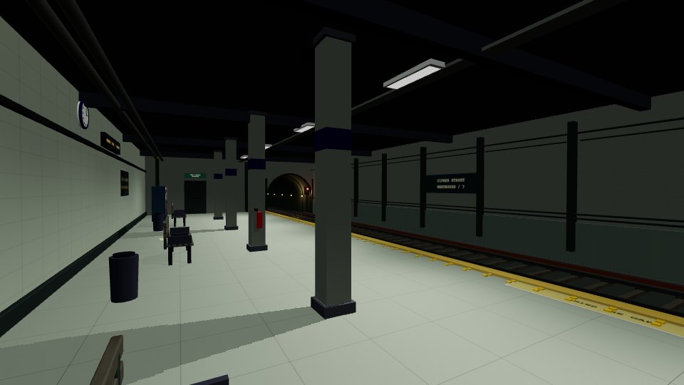 An underground subway platform, tracks, and a tunnel.